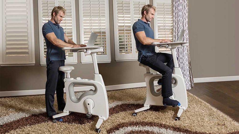 Not Jason Zook riding a stationary standing desk bike